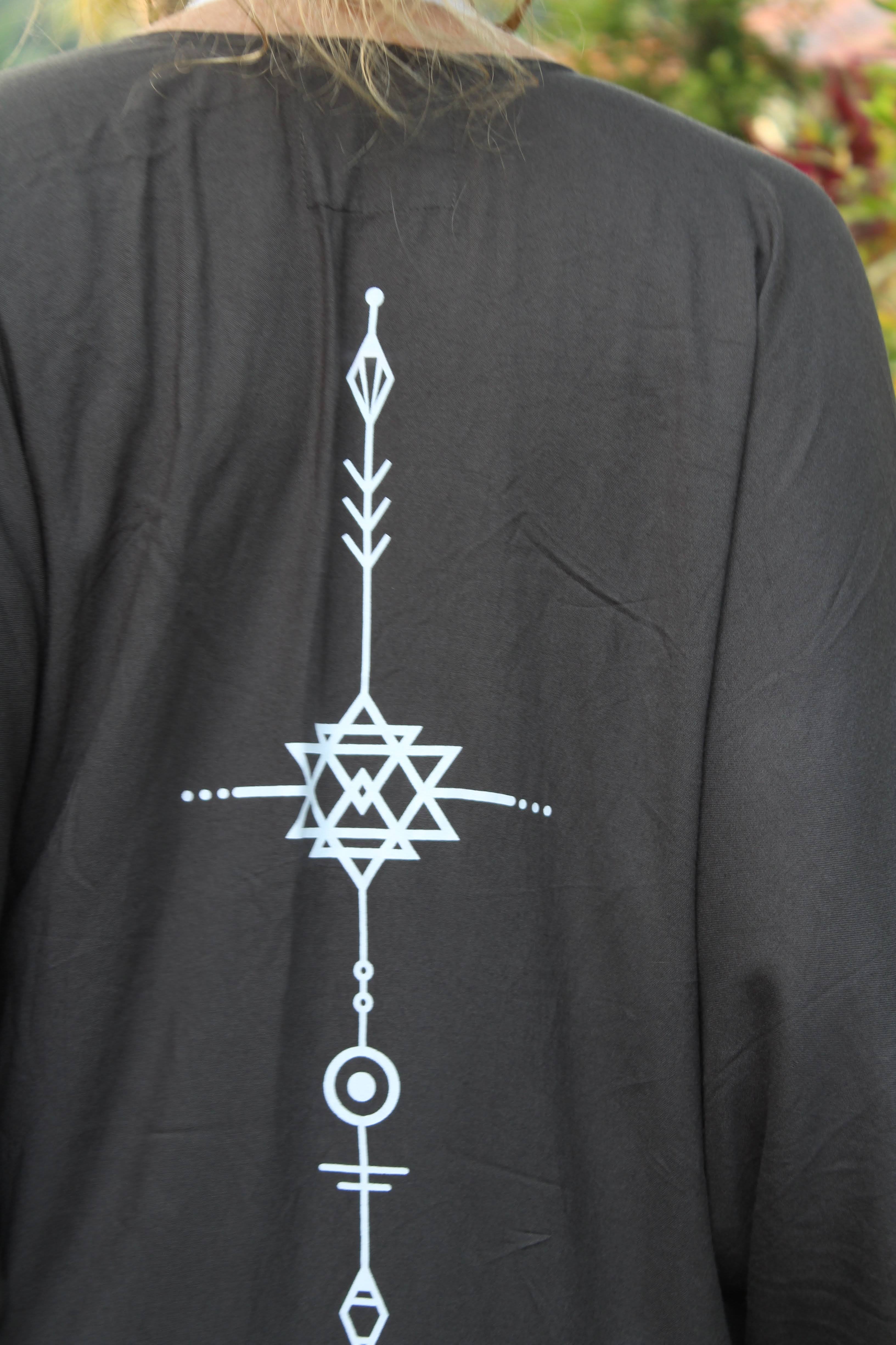 grey kimono with white geometric design on a blurred natural background